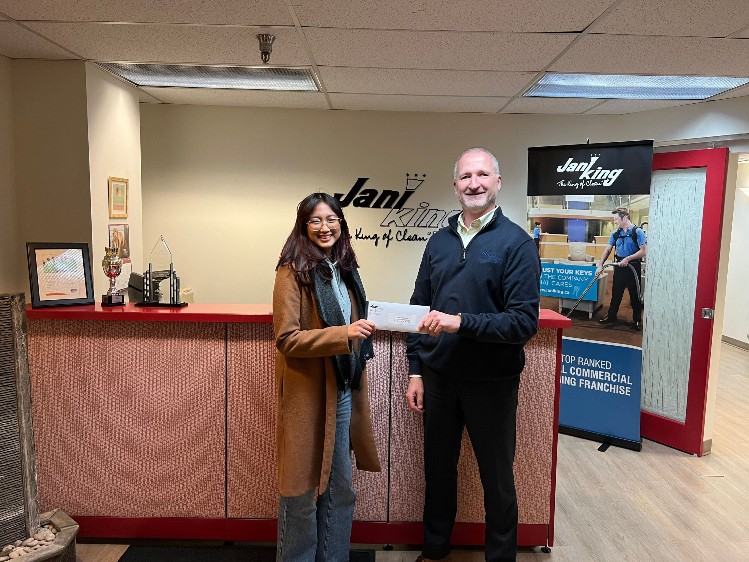 Jamila Natividad receives her scholarship award from Ed McNamara, Regional Director of Jani-King of Nova Scotia.